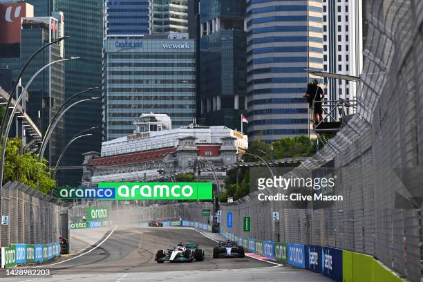 George Russell of Great Britain driving the Mercedes AMG Petronas F1 Team W13 leads Alexander Albon of Thailand driving the Williams FW44 Mercedes on...