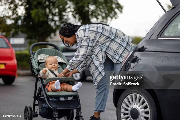 arriving at the shop - kinderwagen stockfoto's en -beelden