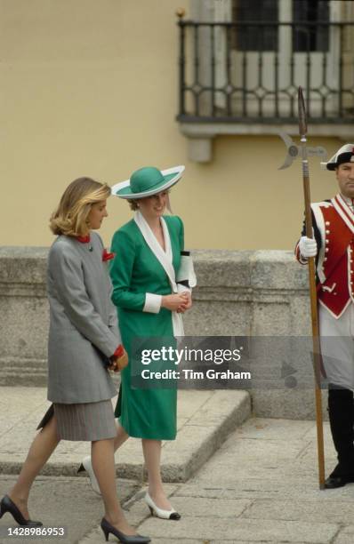 Princess Diana, wearing a green and white suit, walks with Princess Cristina at Pardo Palace, Madrid, April 1987.