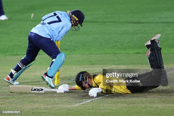 Alyssa Healy of the NSW Breakers attempts to run out Mathilda Carmichael of Western Australia during the WNCL match between New South Wales and...