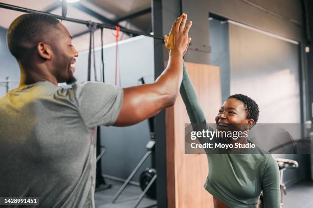 fitness, personal trainer and a black woman high five man for gym goal achievement. motivation, workout and a happy couple training together. health, wellness and exercise support for sports friends. - black female bodybuilder stock pictures, royalty-free photos & images