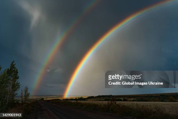 Double rainbow is visible over fields on September 24, 2022 in Mala Komyshuvakha, a village in Izium Raion of Kharkiv Oblast, Ukraine. Almost 70% of...