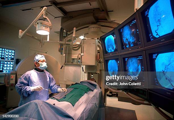 brain surgeon performs neuro surgery on patient - neurosurgery stock-fotos und bilder