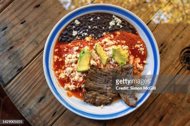 plate of enchiladas huastecas with refried black beans and cecina (air dried beef) - mexican rustic bildbanksfoton och bilder