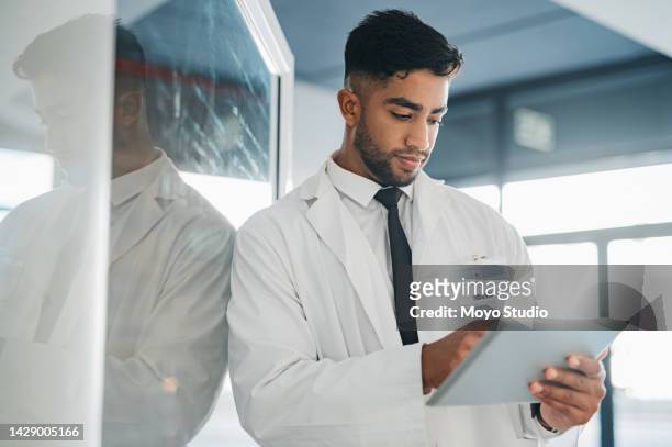 telehealth doctor or medical worker with tablet in hand check results on record, health information or diagnosis. scientist on internet doing research, search innovation application or analyzing. - choosing experiment stockfoto's en -beelden