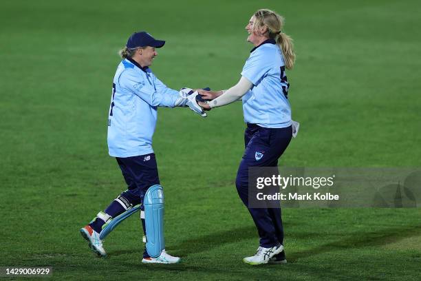 Alyssa Healy and Sammy-Jo Johnson of the NSW Breakers celebrates taking the wicket of Lilly Mills of Western Australia during the WNCL match between...