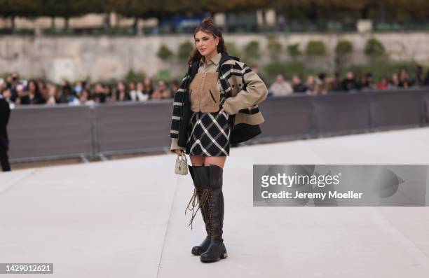 Negin Mirsalehi is seen wearing a beige with black/white checked details long shirt dress, a beige with black/white cape jacket, creme white leather...