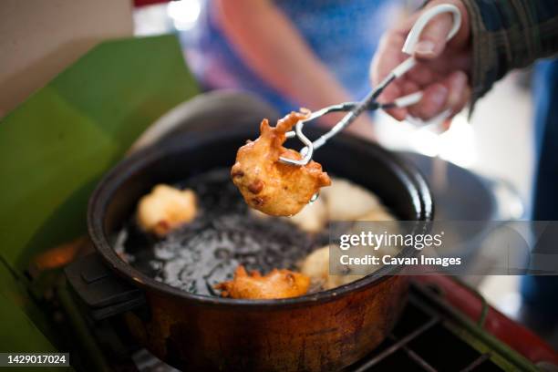 man preparing traditional oliebollen dutch doughnuts, langley, british columbia, canada - oliebollen stockfoto's en -beelden