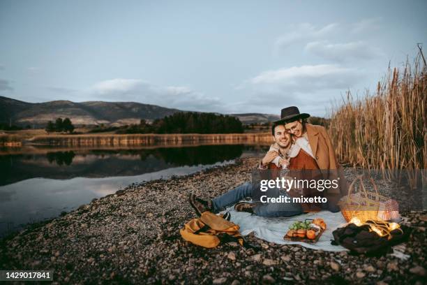 young beautiful couple bonding on a picnic - wine basket stock pictures, royalty-free photos & images