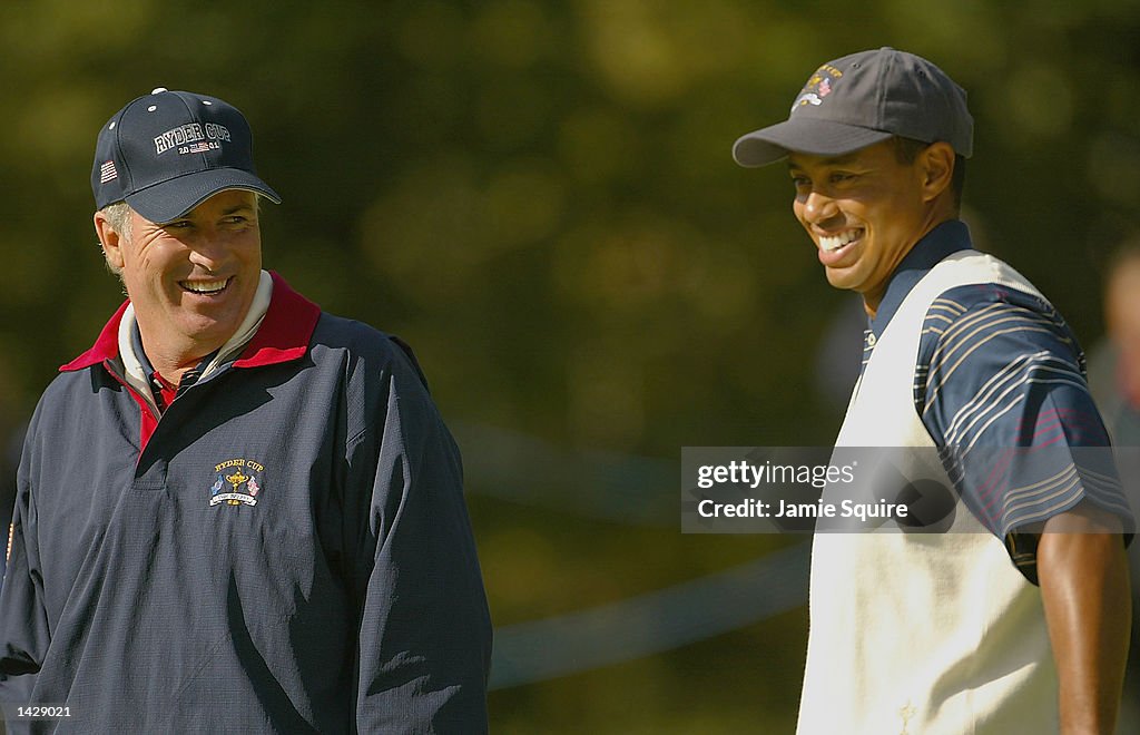 USA team captain Curtis Strange shares a joke with Tiger Woods
