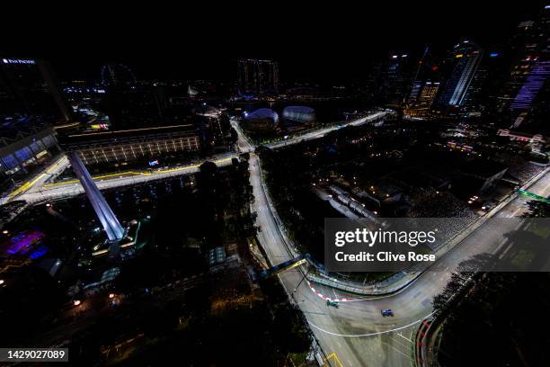 Fernando Alonso of Spain driving the Alpine F1 A522 Renault leads Sebastian Vettel of Germany driving the Aston Martin AMR22 Mercedes during practice...