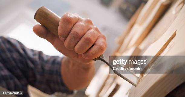 carpenter carving wood with chisel - chisel stock pictures, royalty-free photos & images