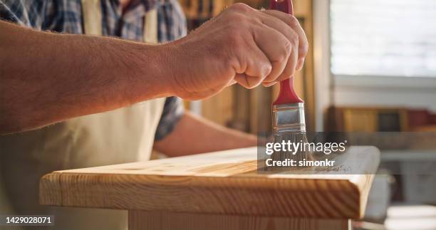carpenter polishing wood with brush - polishing stock pictures, royalty-free photos & images