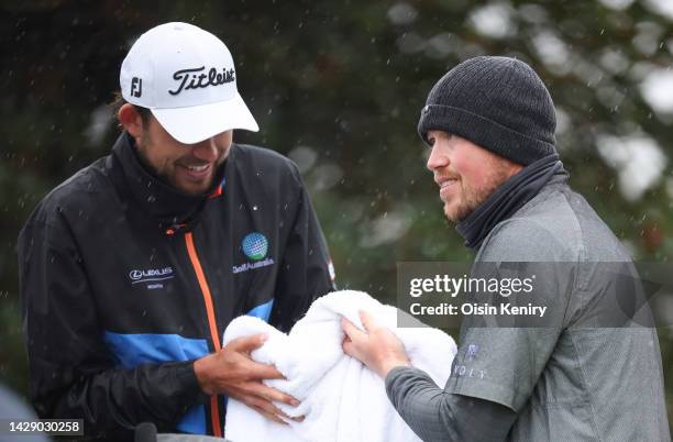 Zach Murray of Australia and Richard Mansell of England dry their hands on the 3rd hole on Day Two of the Alfred Dunhill Links Championship on the...