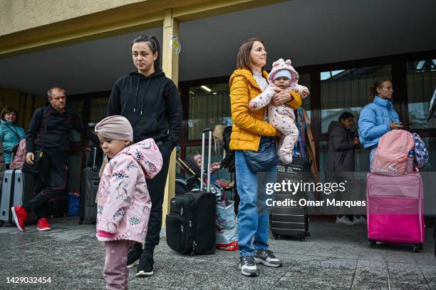 Ira , age 32 and her daughter Yasmine who fled the war in Ukraine and lived in Prague for 7 months, wait to cross passport control to board a train...