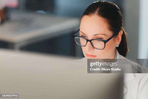 scientist on computer analyse medical test and data from microbiology and genetic research on computer in lab. young woman science worker focus with online medical analytics research in a laboratory - reference book stock pictures, royalty-free photos & images