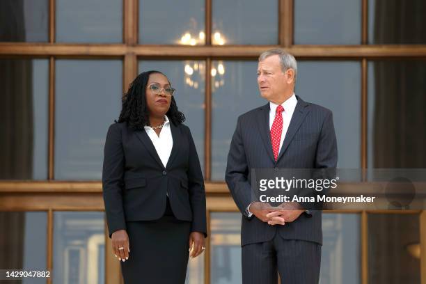 Supreme Court Associate Justice Ketanji Brown Jackson and Chief Justice John Roberts pause for photographs at the top steps of the Supreme Court...