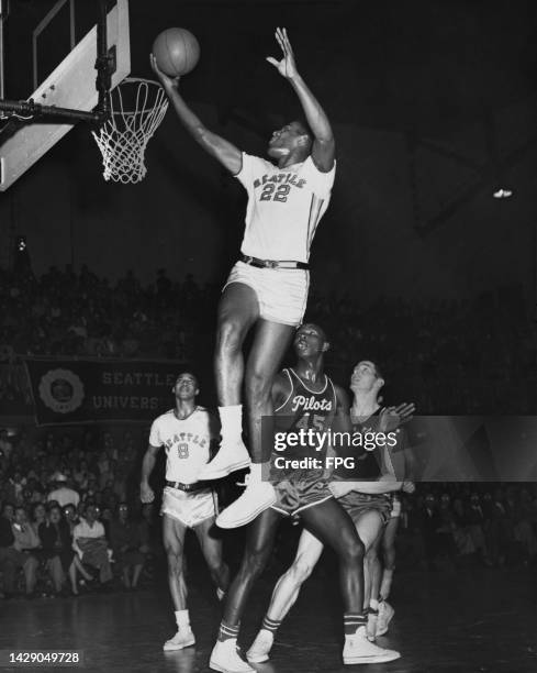 American basketball player Lloyd Murphy, American basketball player Elgin Baylor , both of the Seattle Redhawks, in action against and American...