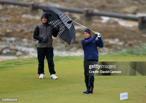 Gianfranco Zola of Italy plays his tee shot on the third hole watched by Francesco Molinari of Italy on Day Two of the Alfred Dunhill Links...