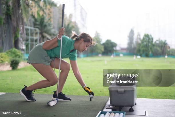 women practice golf in driving range. - driving range stock pictures, royalty-free photos & images