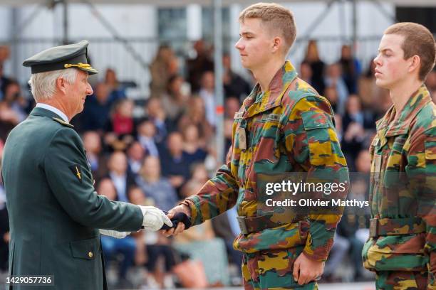 Prince Gabriel of Belgium receives his blue beret from his father King Philippe of Belgium during the Blue Berets Parade at the Royal Military...