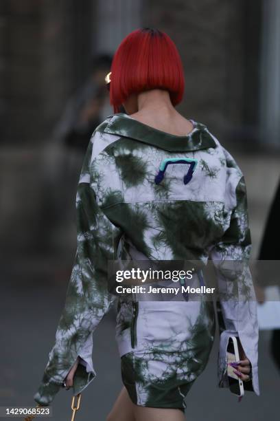 Kiwi Lee is seen wearing a black square Off-White sunglasses, white/green tie-dye blouse shirt and a matching white/green tie-dye skit from Off...