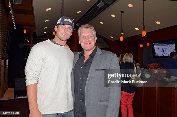 David Freese of the St. Louis Cardinals and former St. Louis Blues player Brett Hull pose for a photo in a suite as they watch Game Two of the...