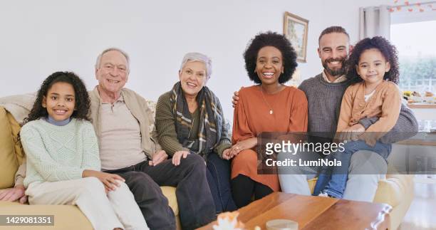 family, love and portrait of interracial parents together with children and grandparents. diverse and happy couple with kids enjoy bonding with grandmother and grandfather in caring home. - family and happiness and diverse imagens e fotografias de stock