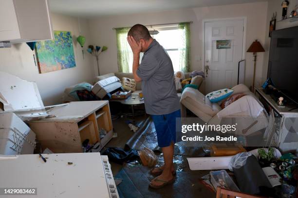 Brian Siebert becomes emotional as he looks at what remains of his home after Hurricane Ian passed through the area on September 30, 2022 in Fort...