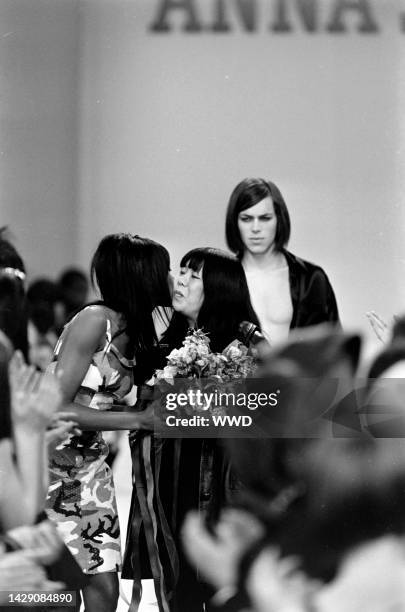 Designer Anna Sui takes a bow during the finale with model Naomi Campbell.