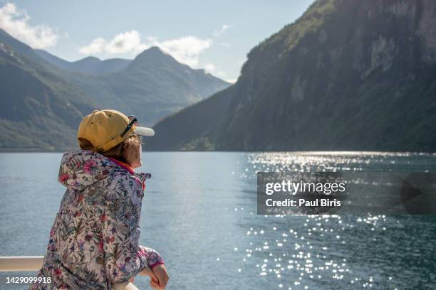 sailing on a cruise ship through a norwegian fjord, geiranger, geirangerfjord, norway, scandinavia, europe - geiranger stock pictures, royalty-free photos & images