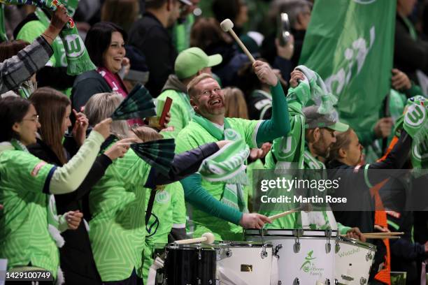 Supporters of VfL Wolfsburg cheer during the FLYERALARM Women's Bundesliga match between VfL Wolfsburg and Bayer 04 Leverkusen at AOK-Stadion on...