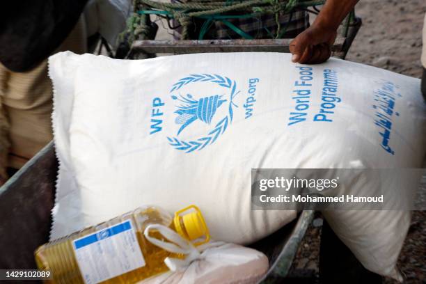 Yemenis who were affected greatly by eight years of conflict, blockade, and economic crisis receive humanitarian aid on September 29 in Sana'a,...