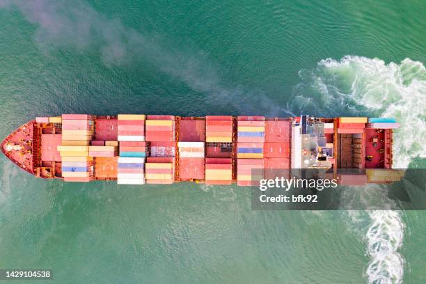 aerial view of container ship vessel cargo carrier in transit. - global entry stock pictures, royalty-free photos & images