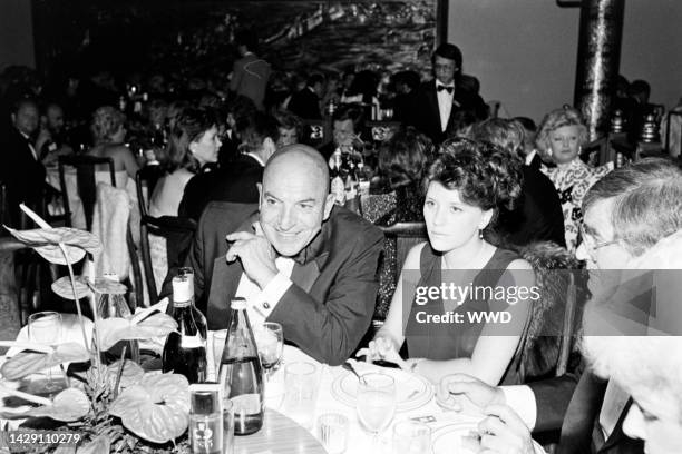 Telly Savalas and Julie Hovland attend a party at Fung Lum, a restaurant in University City, California, on June 15, 1983.