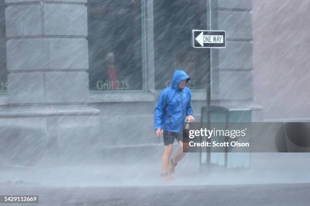 Pedestrian navigates a driving rain from Hurricane Ian on September 30, 2022 in Charleston, South Carolina. Ian hit Florida as a category 4 storm...