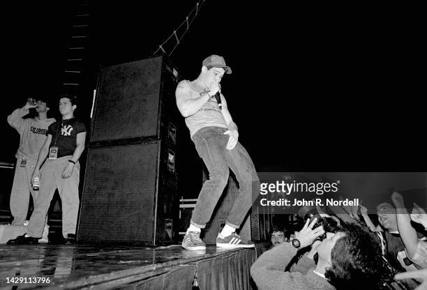 American rapper, guitarist and actor Adam "Ad-Rock" Horovitz, of the American rap rock group Beastie Boys, sings and grabs himself on stage during...