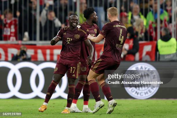 Sadio Mane of Bayern Munich celebrates scoring their side's third goal with teammates Alphonso Davies and Matthijs de Ligt during the Bundesliga...