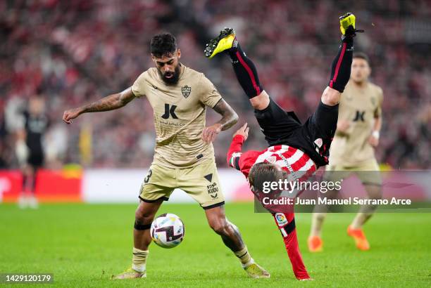 Samu Costa of UD Almeria contends for the aerial ball with Iker Muniain of Athletic Club during the LaLiga Santander match between Athletic Club and...