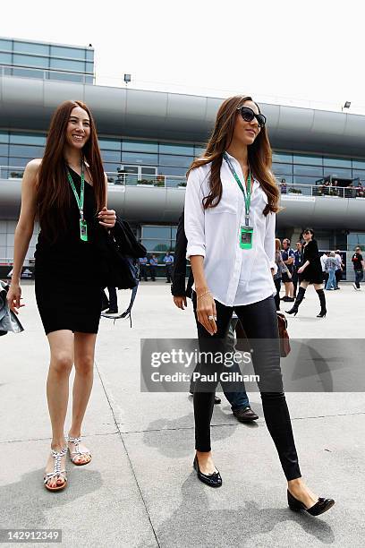 Jessica Michibata , girlfriend of Jenson Button of Great Britain and McLaren arrives in the paddock with her younger sister Angelica Michibata before...