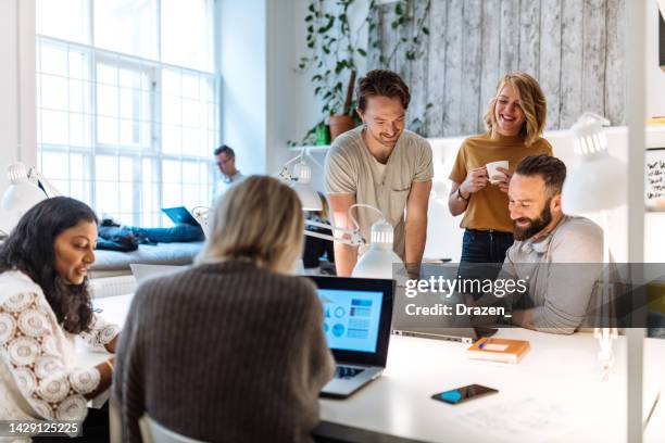entrepreneurs working in modern office and dealing with financial decisions - scandinavian descent stock pictures, royalty-free photos & images