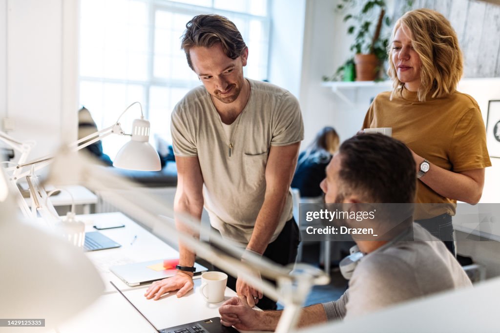 Small group of entrepreneurs brainstorming in office