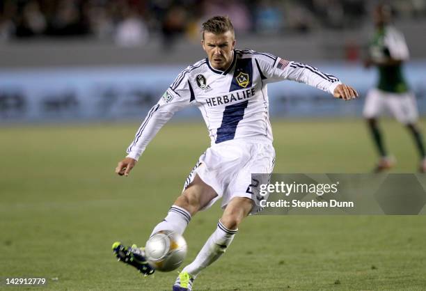 David Beckham of the Los Angeles Galaxy shoots a nd scores a goal in the second half against the Portland Timbers at The Home Depot Center on April...