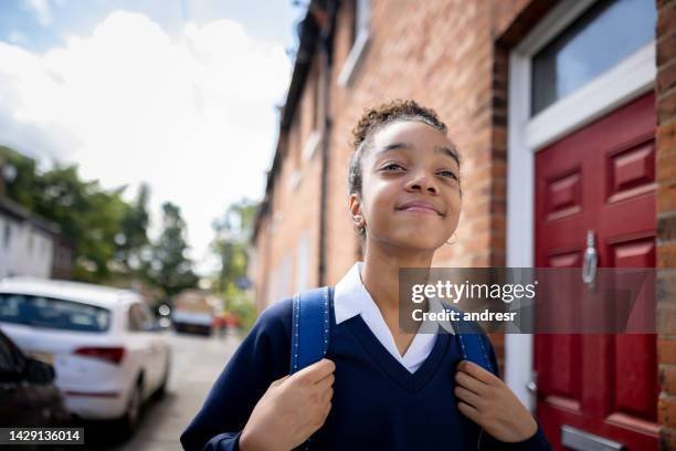 happy teenage girl walking to school - african american school uniform stock pictures, royalty-free photos & images