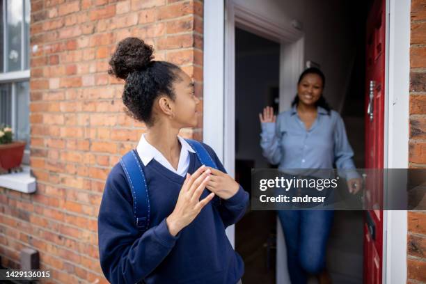 girl going to school and waving goodbye to her mother - child waving stock pictures, royalty-free photos & images