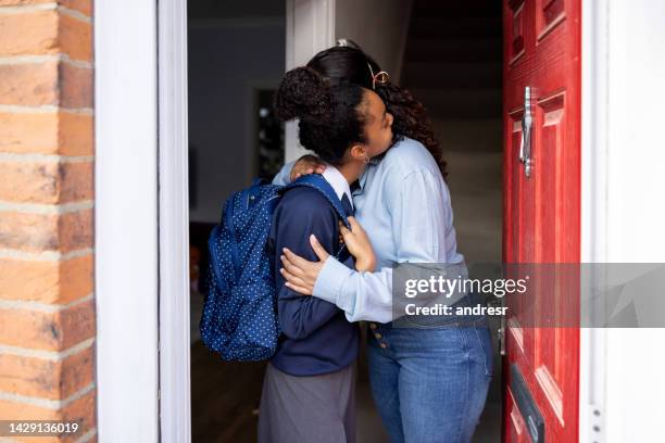 mother saying goodbye to her daughter going to school - first day school hug stock pictures, royalty-free photos & images