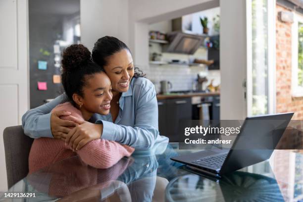 loving mother and daughter getting good news online - application form stock pictures, royalty-free photos & images