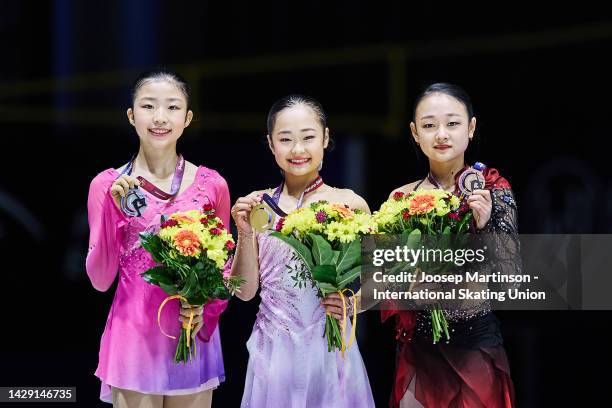 Mone Chiba of Japan, Mao Shimada of Japan and Chaeyeon Kim of Korea pose in the Junior Women's medal ceremony during the ISU Junior Grand Prix of...