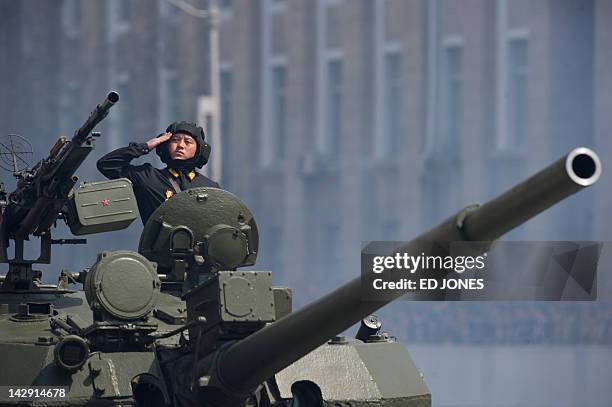 Soldier salutes atop a tank during a military parade in honour of the 100th birthday of the late North Korean leader Kim Il-Sung in Pyongyang on...