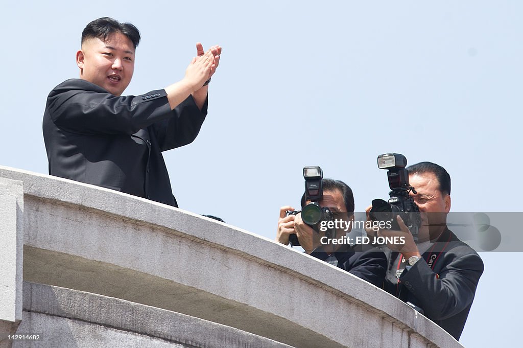 North Korean leader Kim Jong-Un (L) appl